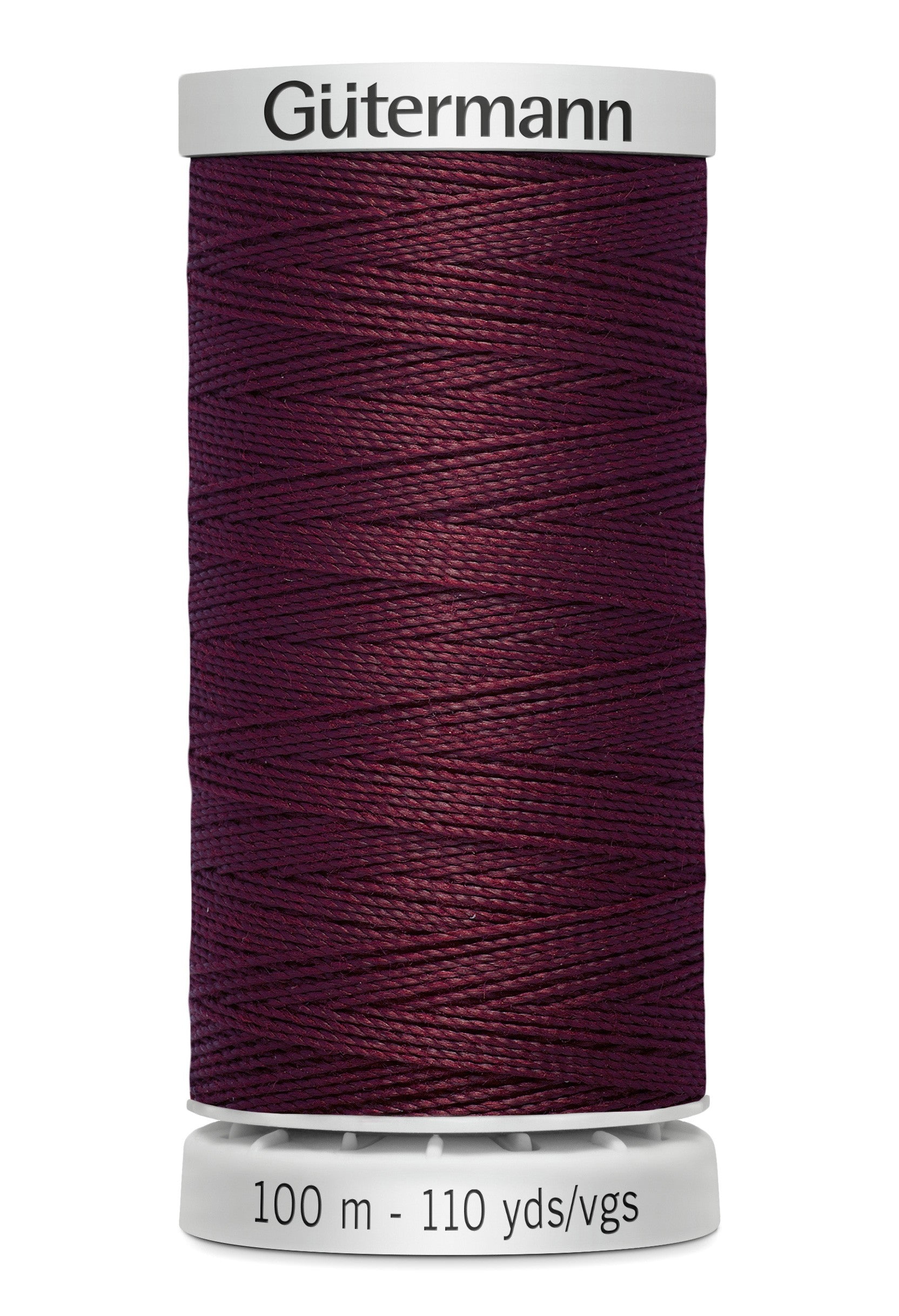 Spool of Gutermann thread in dark purple on a white background