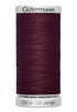 Spool of Gutermann thread in dark purple on a white background