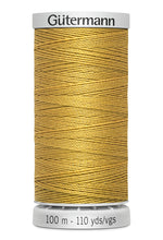 Spool of yellow thread with 'Gütermann' branding on a white background