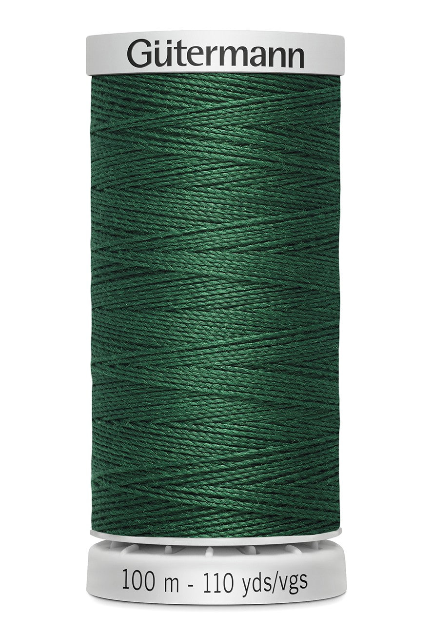 Spool of green thread with 'Gütermann' branding on a white background