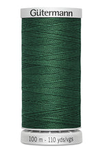 Spool of green thread with 'Gütermann' branding on a white background