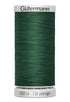 Spool of green thread with 'Gütermann' branding on a white background