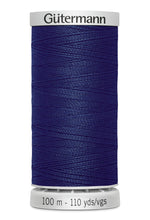Spool of blue thread with 'Gütermann' branding on a white background