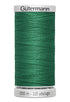 Green spool of Gutermann thread on a white background