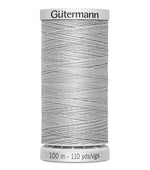 Spool of Gutermann thread on a white background