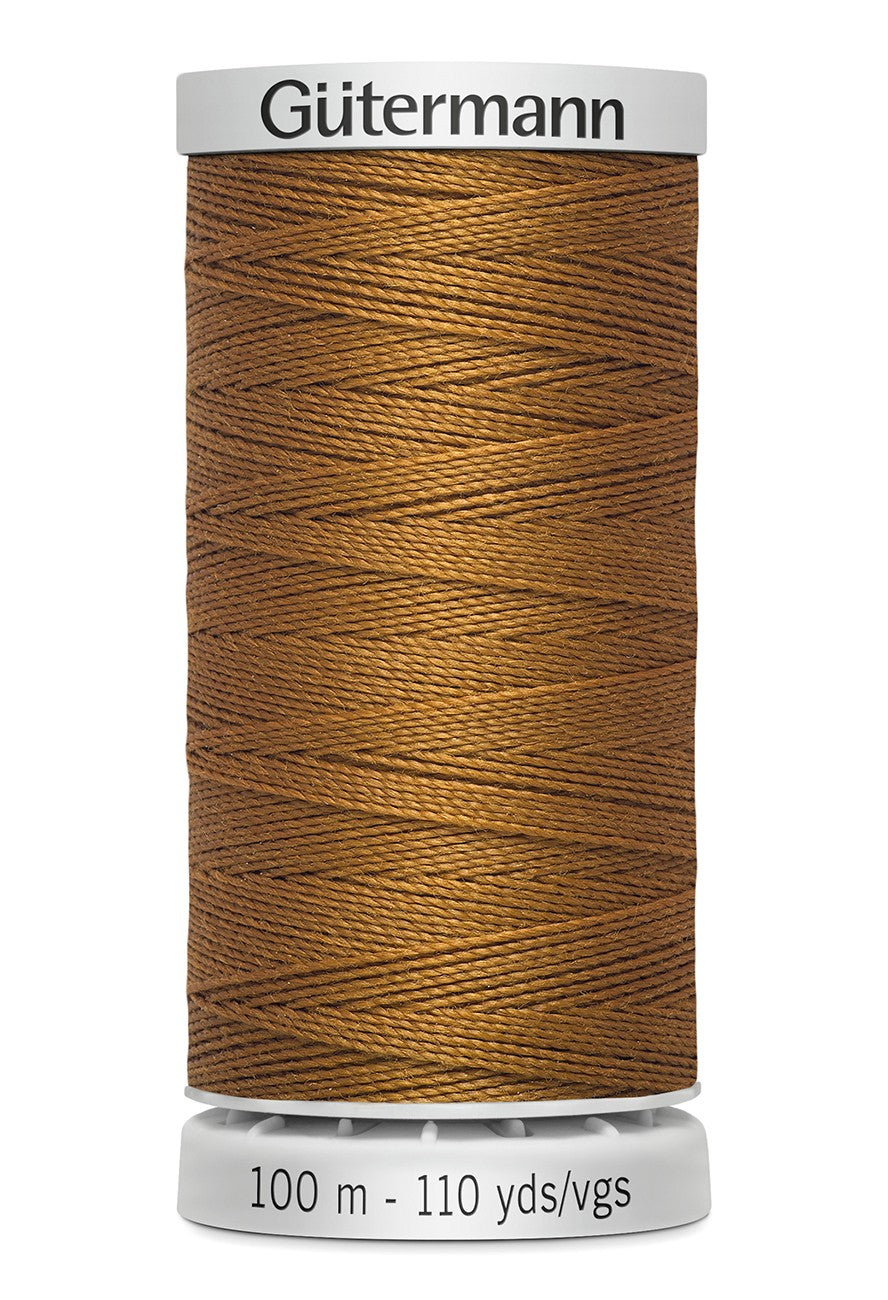Spool of brown thread with 'Gütermann' branding on a white background