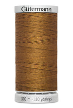 Spool of brown thread with 'Gütermann' branding on a white background
