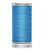 Spool of blue thread with 'Gütermann' branding on a white background