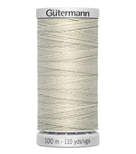 Spool of Gutermann thread on a white background