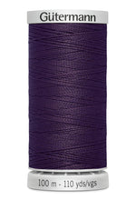 Spool of purple thread with 'Gütermann' branding on a white background
