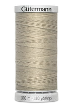 Spool of Gutermann thread on a white background