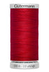 Red spool of Gütermann thread on a white background