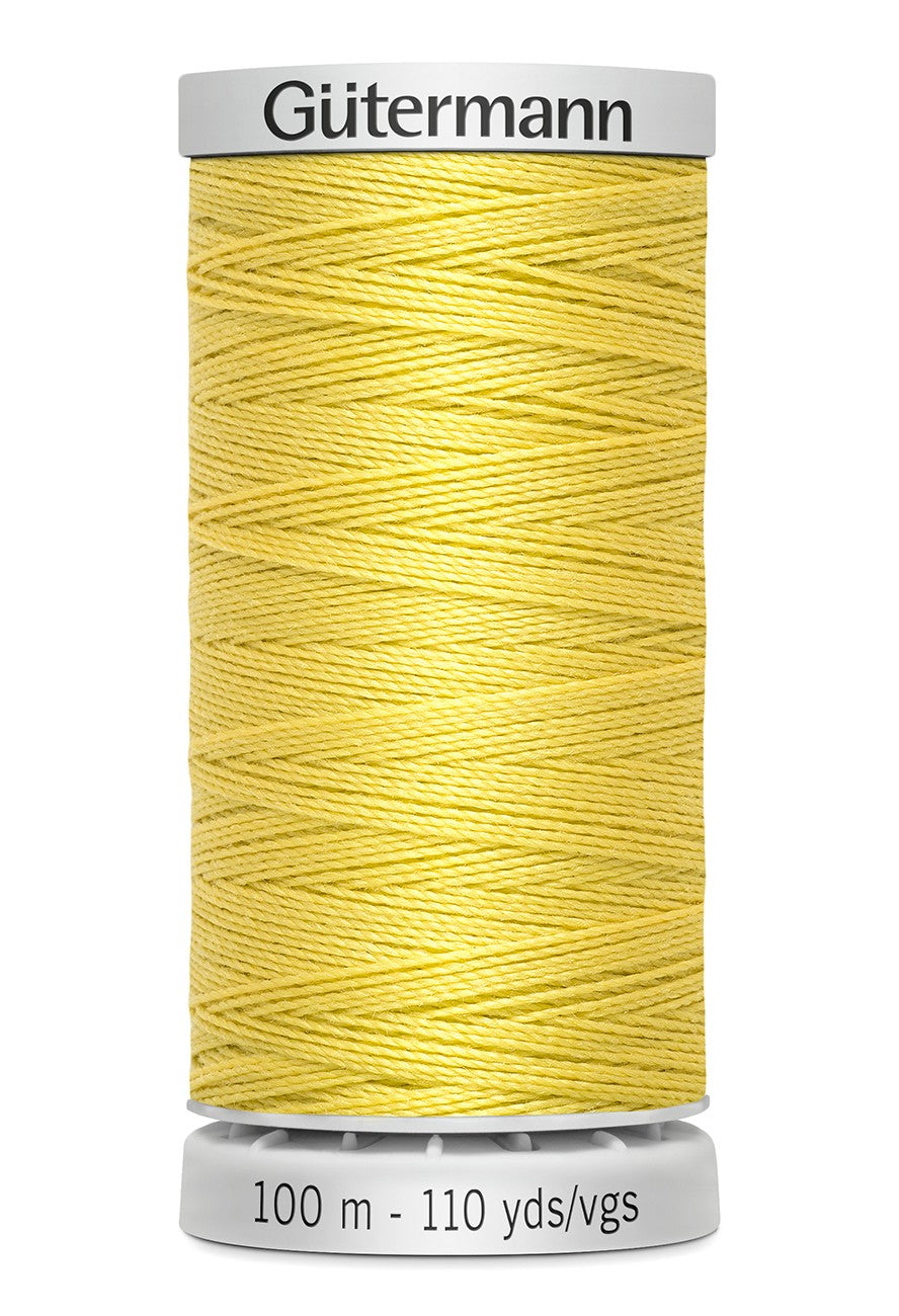 Spool of yellow thread with 'Gütermann' branding on a white background