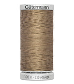 Spool of Gütermann thread on a white background