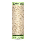 Spool of Gutermann thread on a white background
