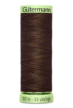 Spool of Gutermann thread on a white background