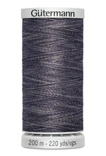 Spool of Gutermann thread on a white background