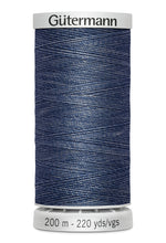 Spool of blue thread with 'Gütermann' branding on a white background