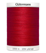 A spool of Gutermann sewing thread in a vibrant red color, shown against a plain white background.