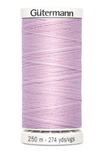 Spool of purple thread with 'Gutermann' branding on a white background