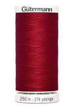 Spool of Gutermann thread on a white background