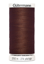 Spool of Gutermann thread on a white background