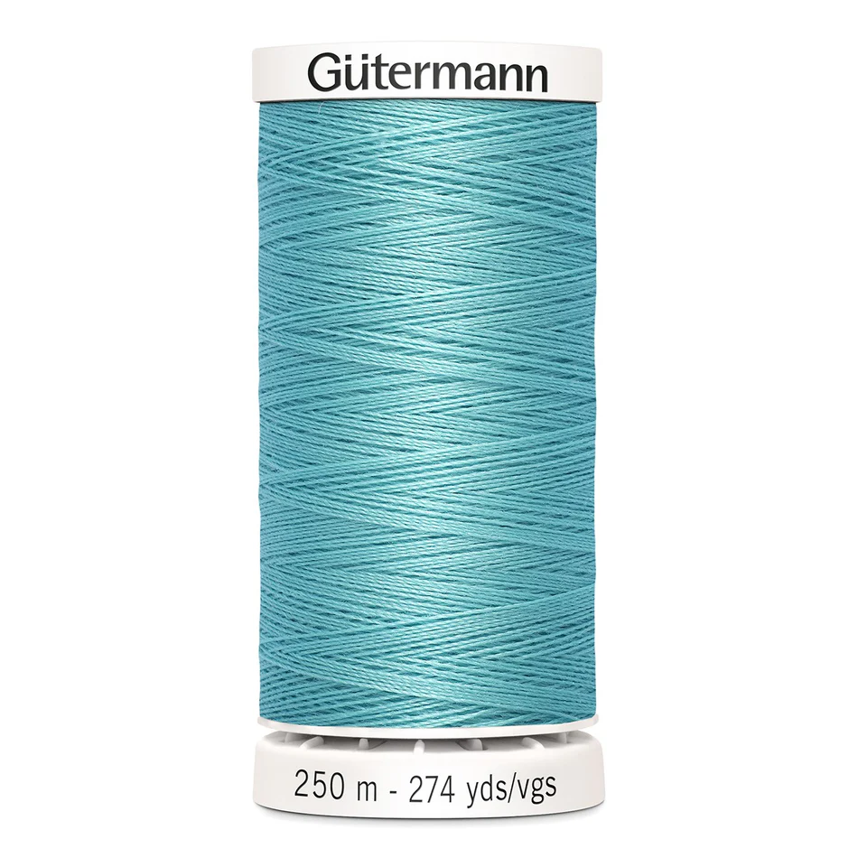 Spool of blue thread with 'Gütermann' branding on a white background