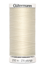 Spool of Gutermann thread on a white background