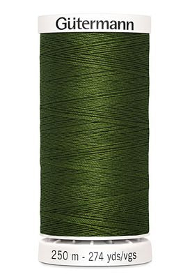 Green spool of Gütermann thread on a white background