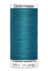 Spool of Gutermann thread in blue on a white background