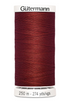 Spool of red thread with 'Gütermann' branding on a white background
