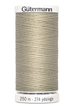 Spool of Gutermann thread on a white background
