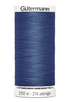 Spool of blue Gutermann thread on a white background