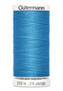 Blue spool of Gutermann thread on a white background
