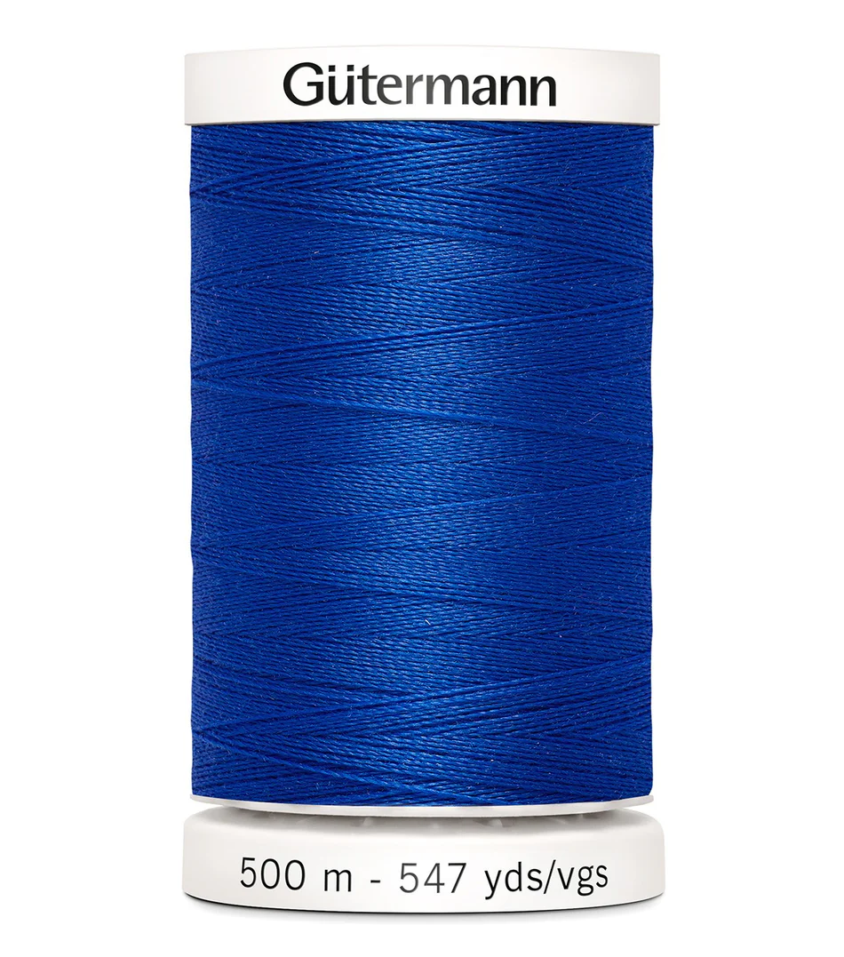 Blue spool of Gütermann thread on a white background