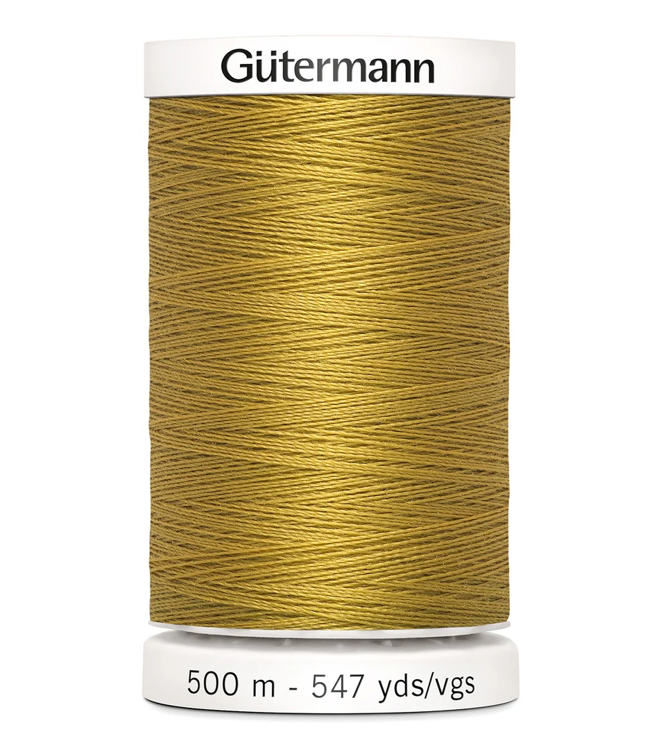 Spool of Gütermann thread with a mustard yellow color on a white background