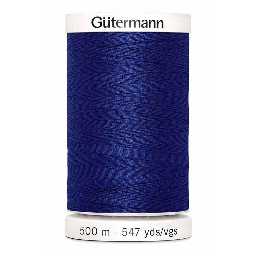 Spool of blue Gutermann thread on a white background