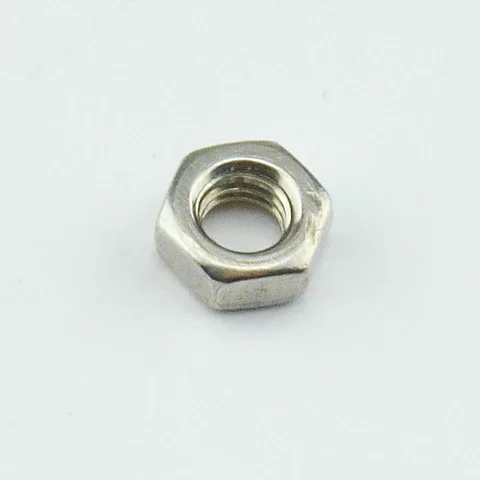 A single silver metal hex nut with a threaded center hole, photographed on a plain light gray background.
