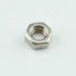 A single silver metal hex nut with a threaded center hole, photographed on a plain light gray background.
