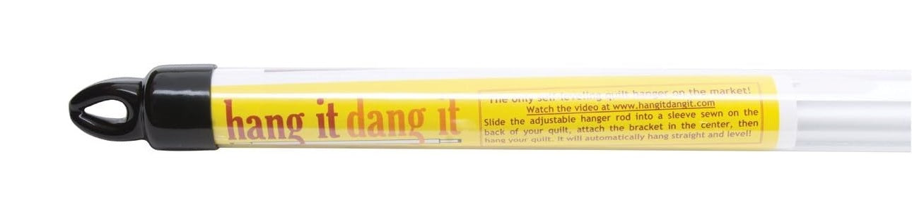White quilt hanger with black cap and yellow label reading 'hang it dang it' on a white background