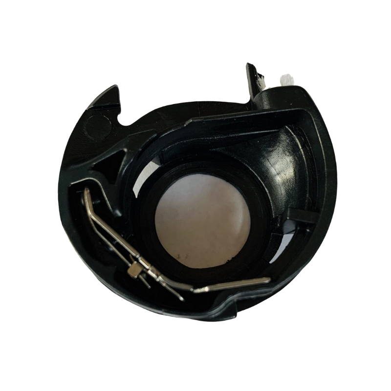 A black plastic circular component with a central circular opening and a small metal spring inside, isolated on a white background.