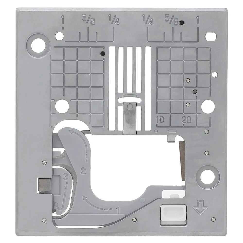 A square gray metal mounting plate or bracket with pre-drilled holes, cutouts, embossed measurement markings, and a small white rectangular component near the bottom right, shown on a plain white background.