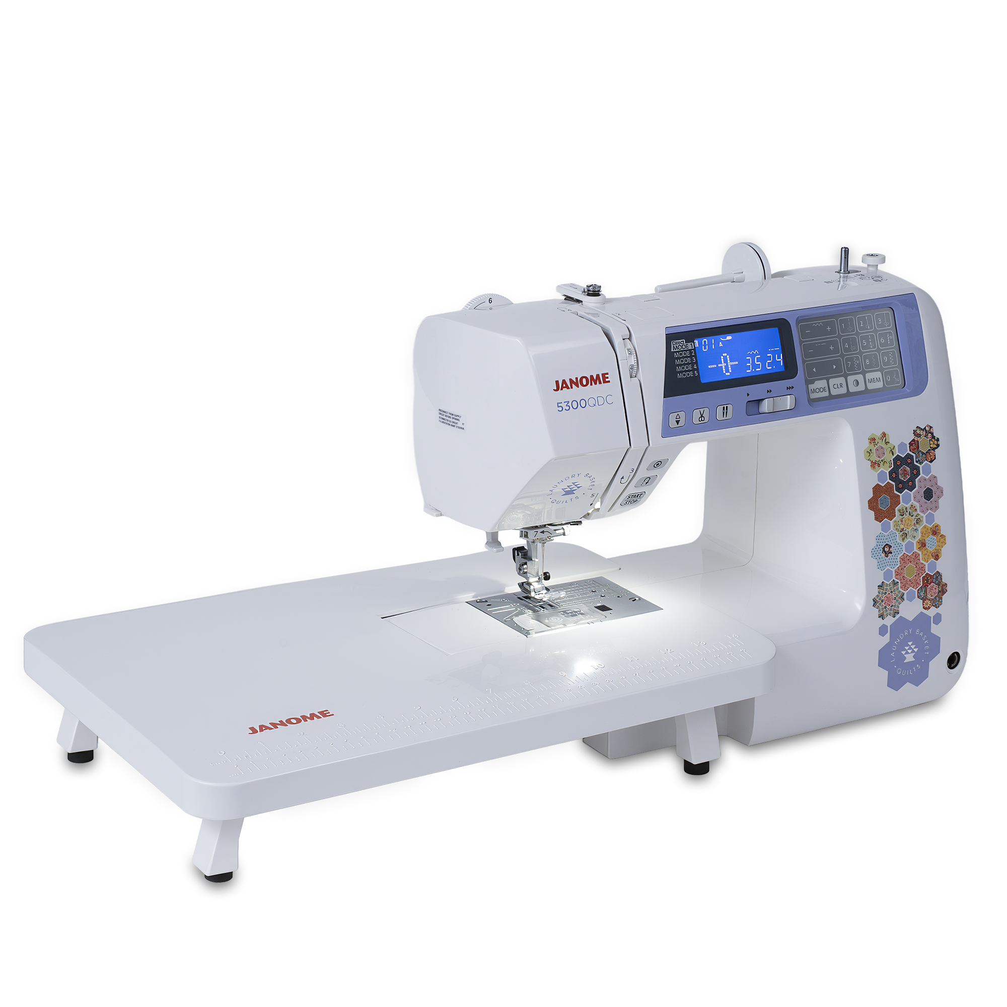 Janome DX900QC sewing machine with an extended white work table, shown on a clean white background. The machine features a white body with a blue digital display screen, red Janome branding, and colorful floral patterns on the side.