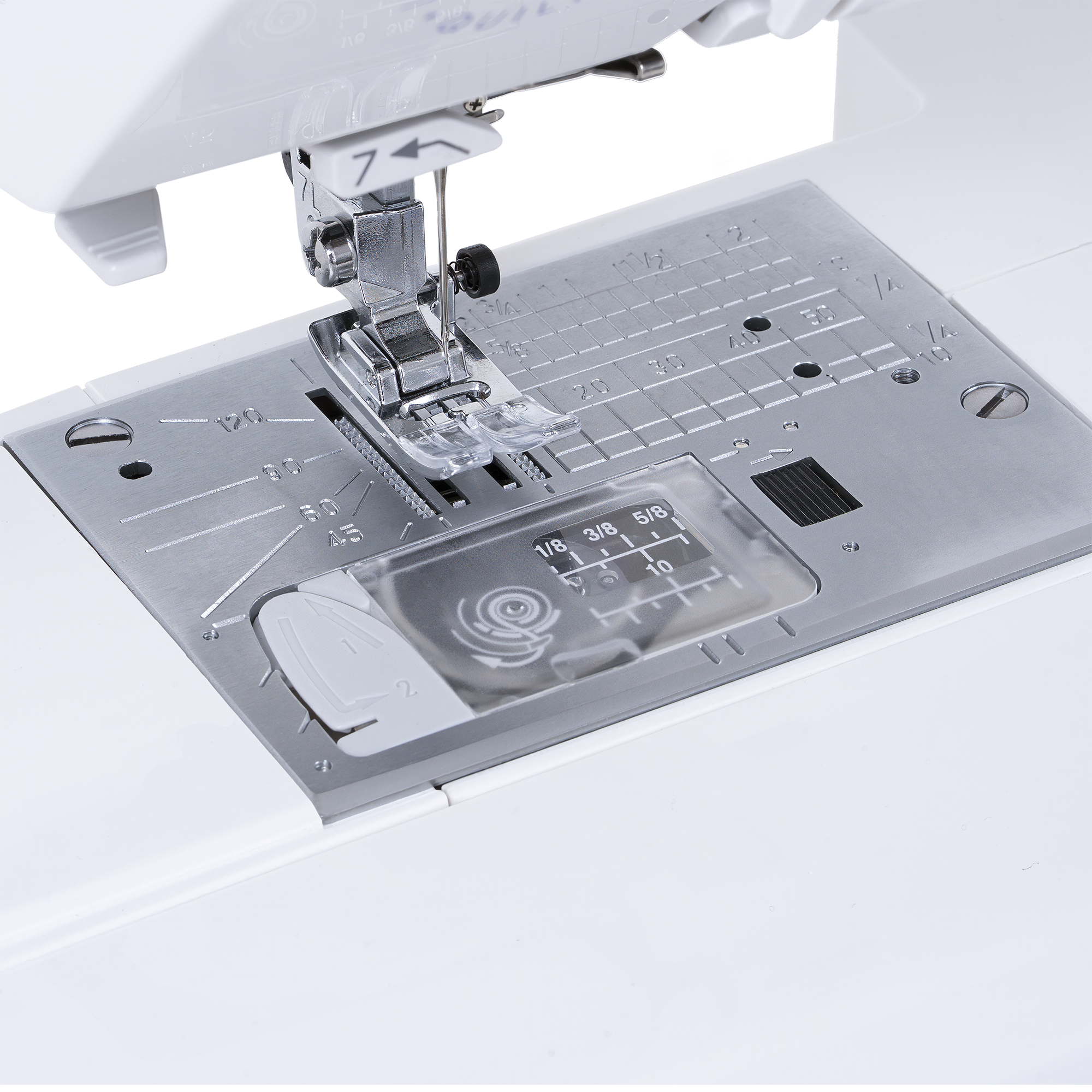 Close-up of a white and silver sewing machine showing the presser foot, needle area, and a transparent fabric measurement guide with size markings.