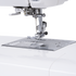 Close-up of a white sewing machine showing the needle area, presser foot, thread guide, and metal needle plate against a clean white background.