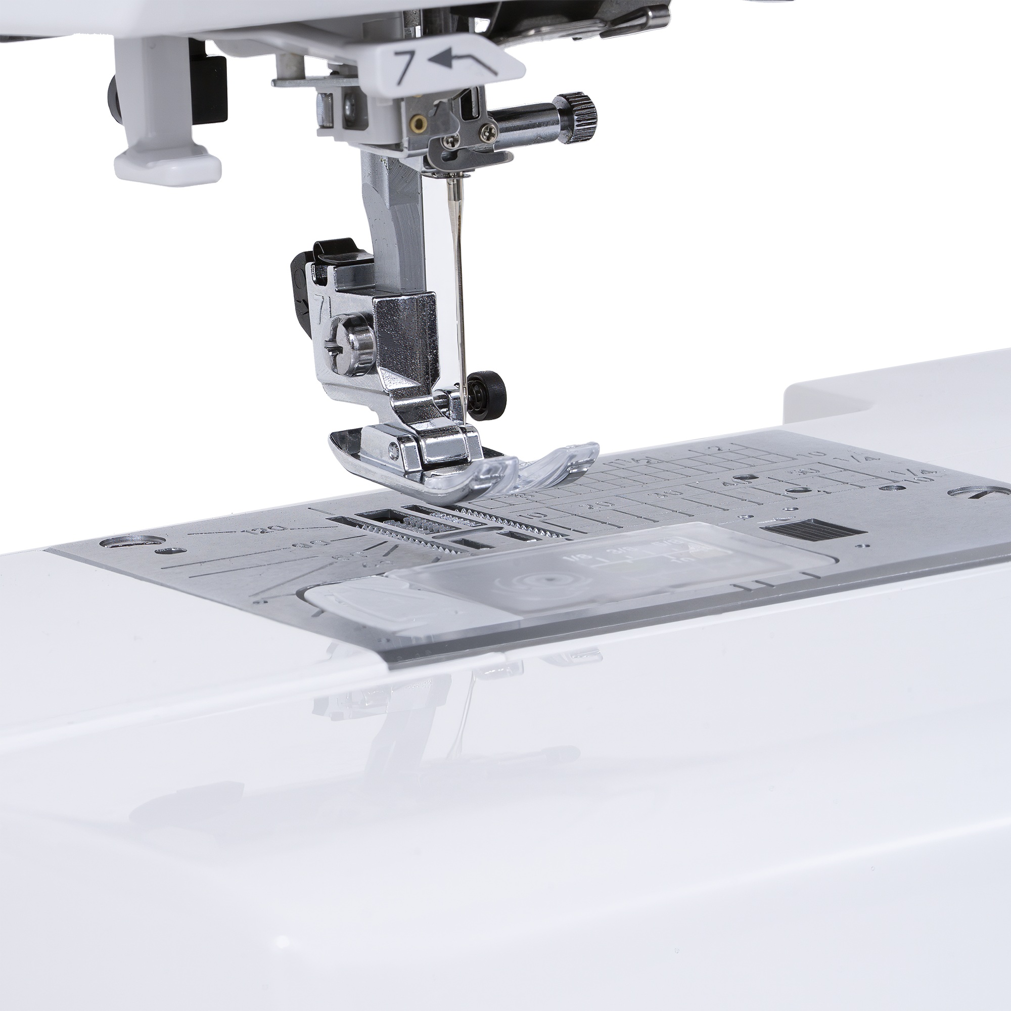Close-up of a sewing machine needle area with a metallic presser foot, needle, and fabric guide plate on a white sewing machine bed.