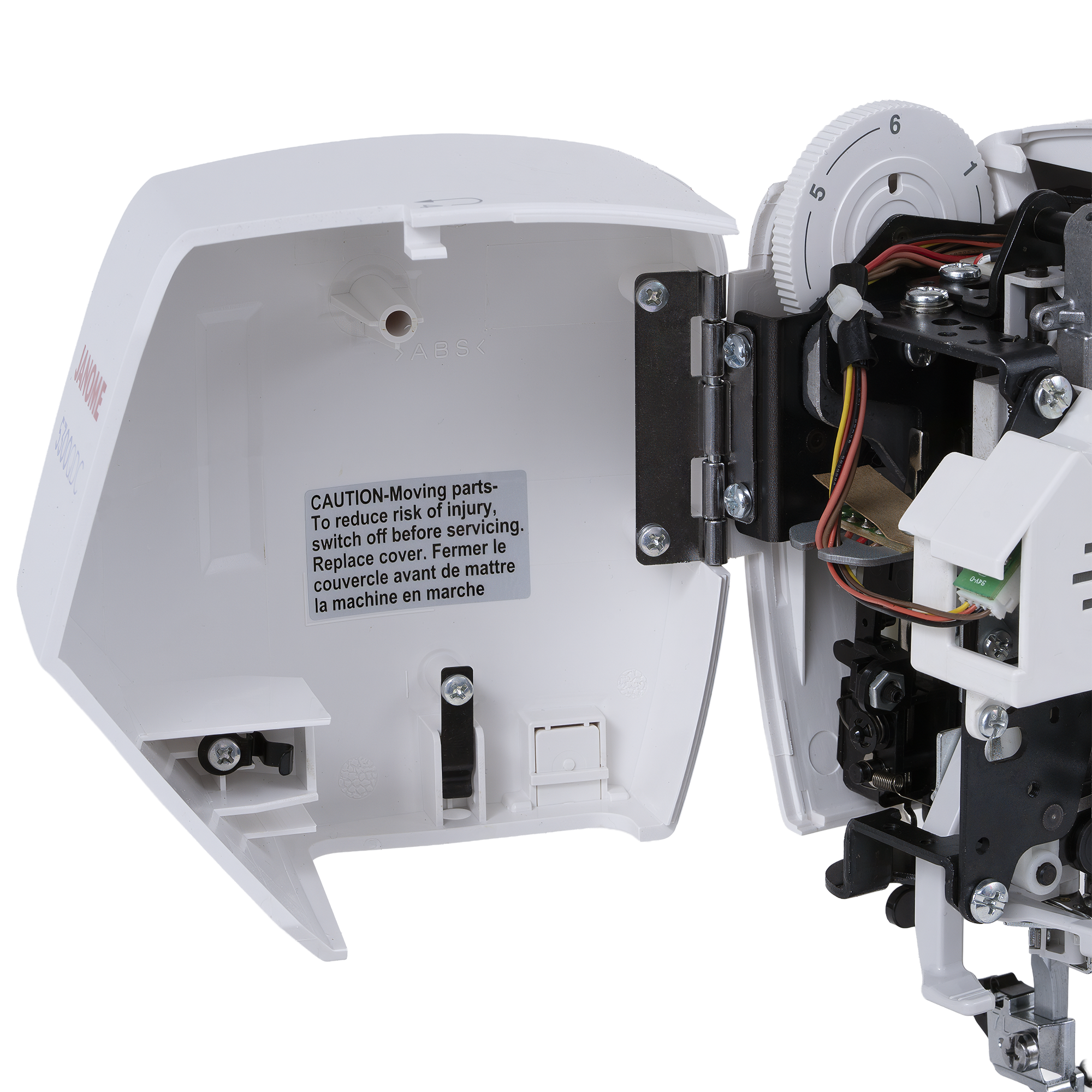 Close-up of a white sewing machine electronic cover with a warning label on the inside, shown open next to internal machinery components and wiring on a white background.