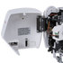 Close-up of a white sewing machine electronic cover with a warning label on the inside, shown open next to internal machinery components and wiring on a white background.