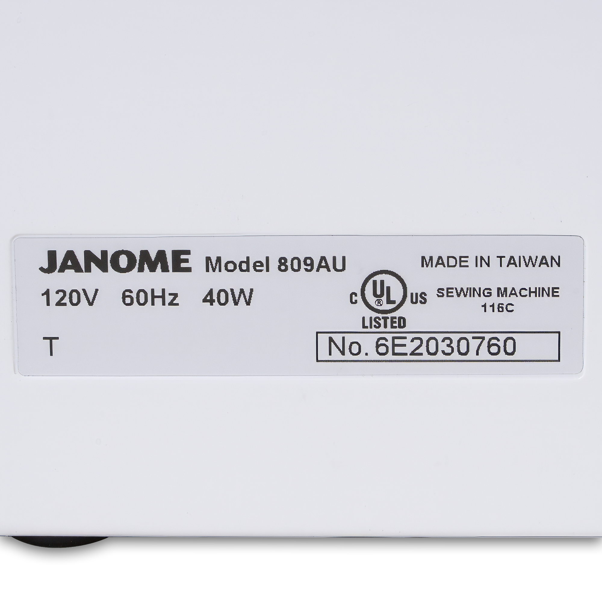 Close-up of a JANOME sewing machine label showing model 809AU, 120V 60Hz 40W, made in Taiwan, with UL listed markings on a white surface.