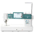A Janome Continental M6 sewing machine in white and teal, featuring a digital touchscreen display, floral graphic on the front, and an extended arm, shown against a solid white background.